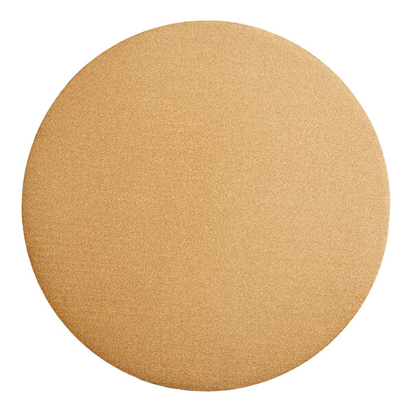 A close-up of a Wilton gold glitter cake circle with a tan background.