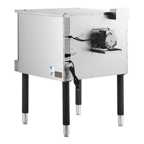A stainless steel appliance with four black legs, a visible motor on the side, and power cords attached.