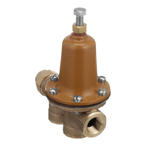 A close-up of a brown Watts water pressure reducing valve with brass fittings.