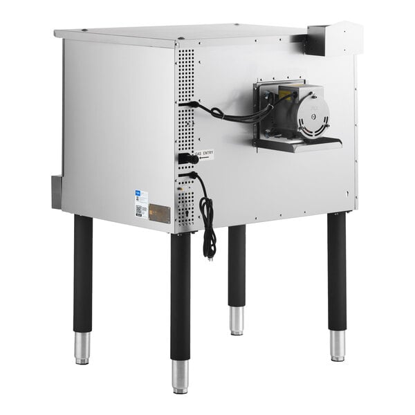 A stainless steel appliance with four black legs, a visible electric motor on the side, and power cords hanging down.