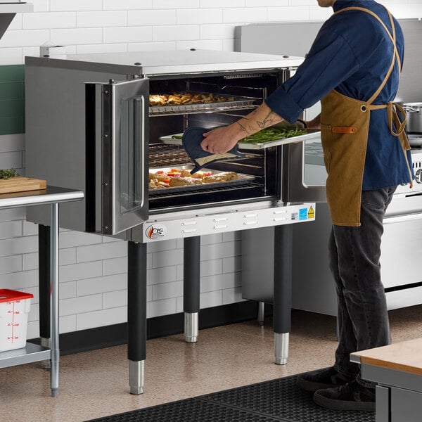 A single deck standard depth full size electric convection oven being used in a commercial kitchen.