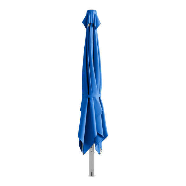 A Lancaster Table & Seating cobalt blue cantilever umbrella on a metal pole with a white band.