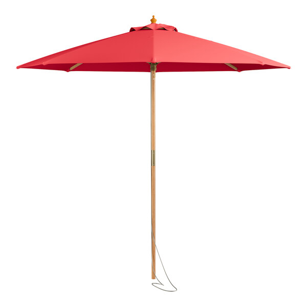 A close up of a Lancaster Table & Seating red umbrella with a wooden pole.