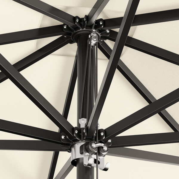 A close up of a Lancaster Table & Seating black aluminum umbrella with metal poles.