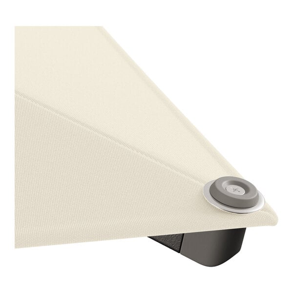 A close up of a white fabric surface on a Lancaster Table & Seating ivory umbrella with a black pulley lift button.