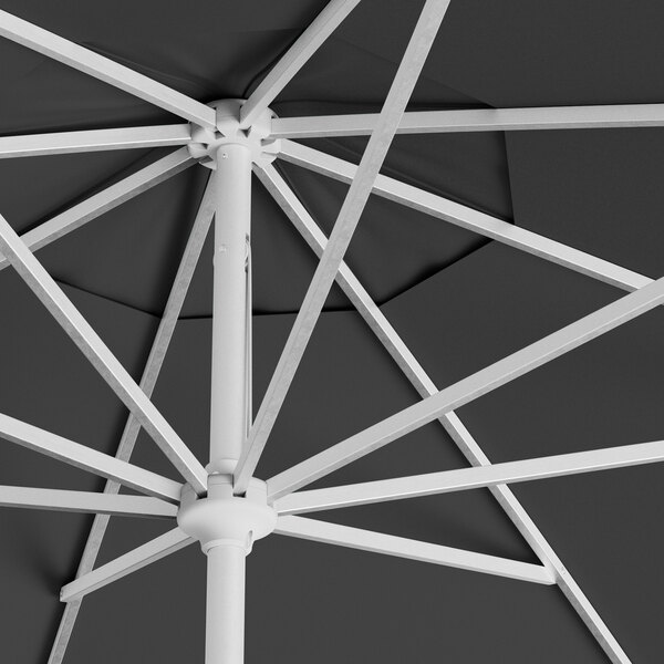 A close up of a black Lancaster Table & Seating round umbrella with a silver pole.