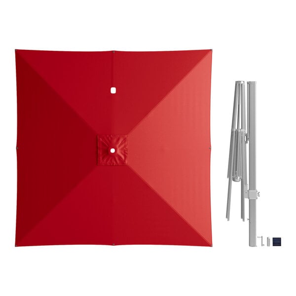 A red square cantilever umbrella with lights and a metal pole.