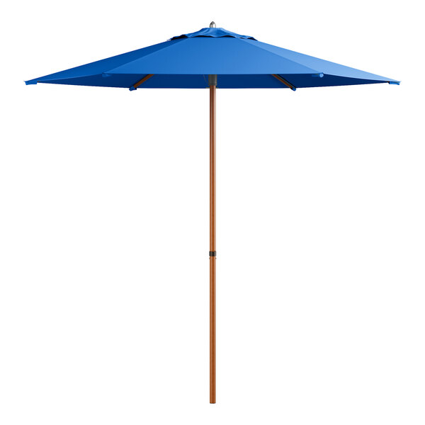A blue umbrella with a wood pole.