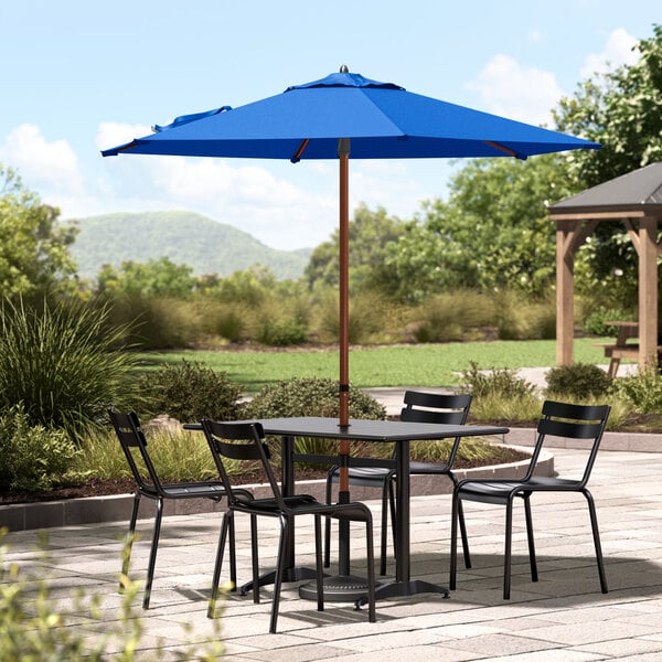 A Lancaster Table and Chairs with a Blue Umbrella.