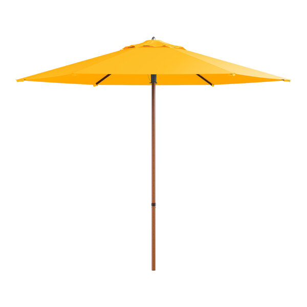 A yellow umbrella with a woodgrain pole.