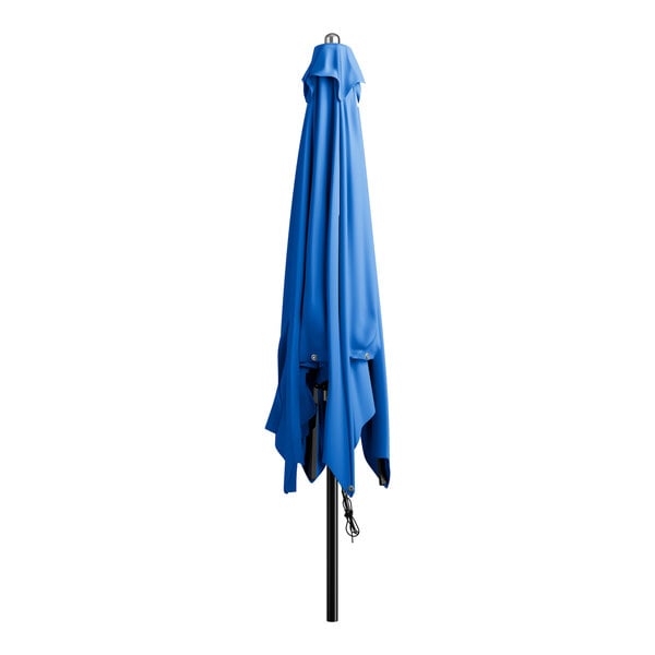 A blue umbrella on a black pole.