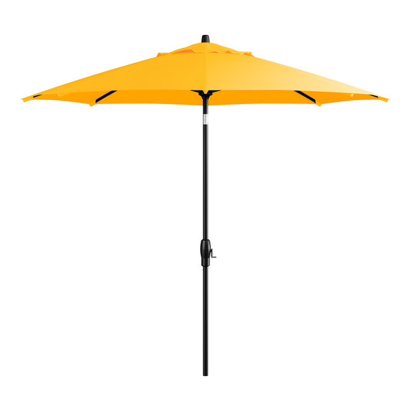 A yellow Lancaster Table & Seating umbrella on a black stand.