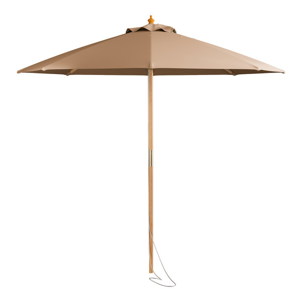 A tan umbrella with a wooden pole and a brown shade.