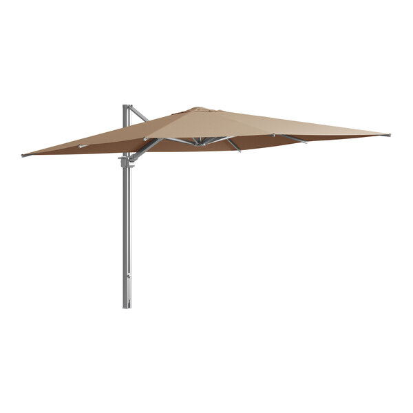 A Lancaster Table & Seating cantilever umbrella with a wheat shade on a metal pole.