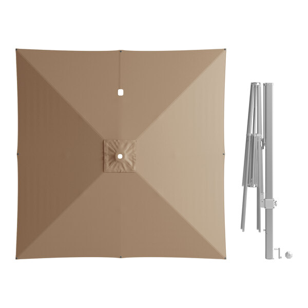A top view of a square tan Lancaster Table & Seating cantilever umbrella with a crank lift.