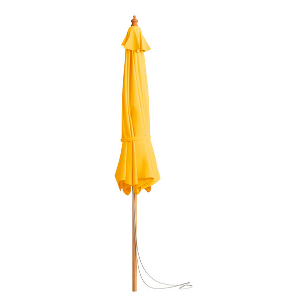 A yellow umbrella with a wooden pole.