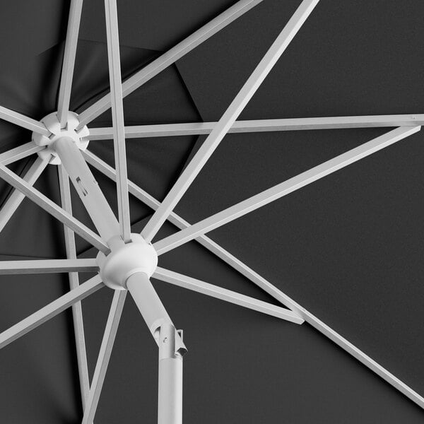 A close up of a black Lancaster Table & Seating round umbrella.