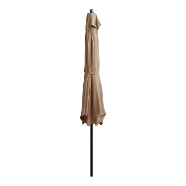 A closed tan umbrella on a black pole.