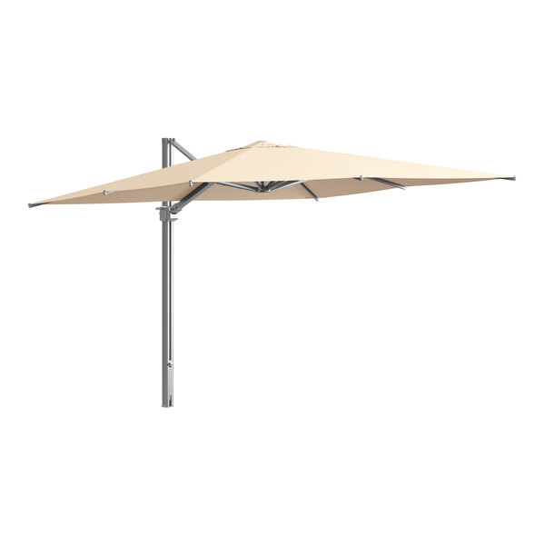 A white umbrella with a metal pole over a white table.