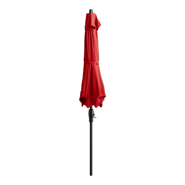 A red umbrella on a black pole.