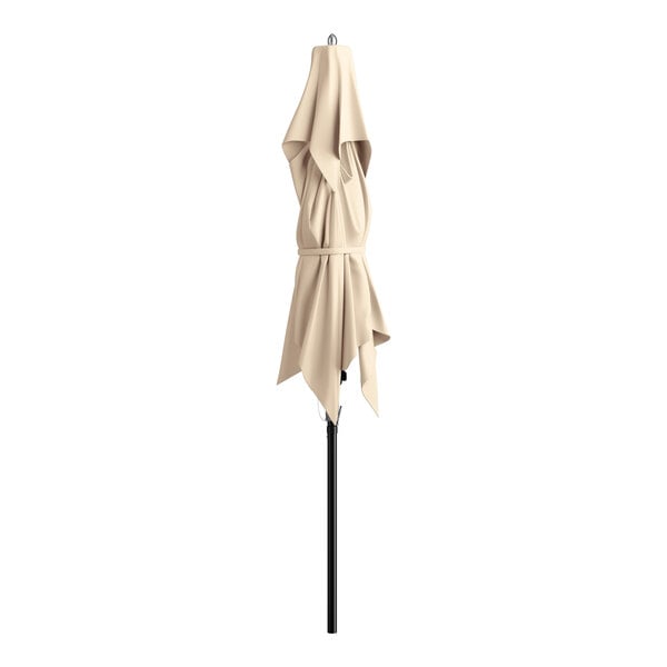A closed beige square umbrella with a black pole.