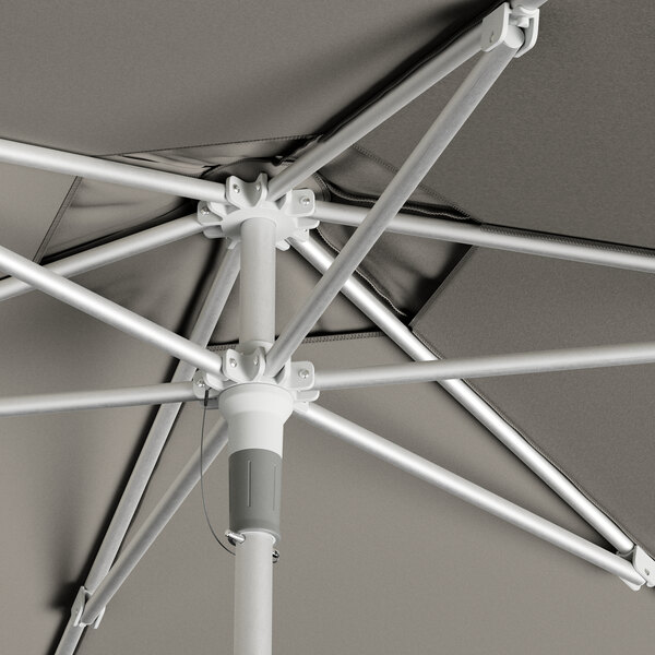 A Lancaster Table & Seating round umbrella with a metal pole.
