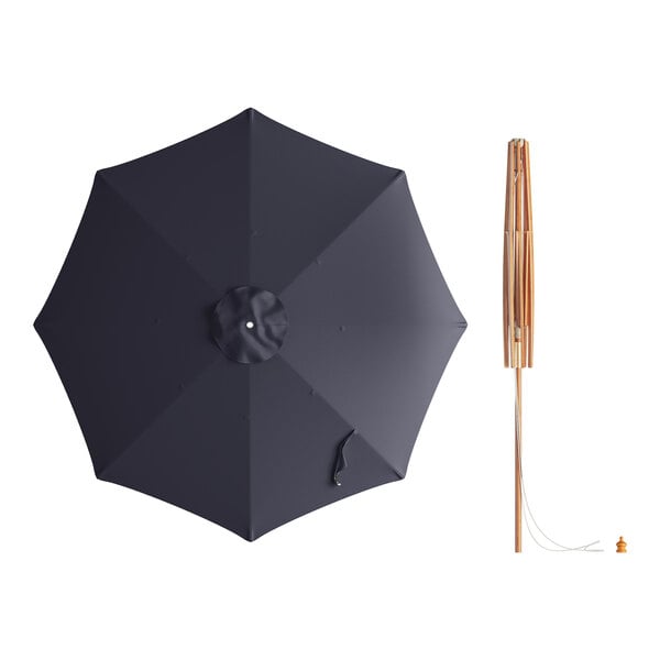 A Lancaster Table & Seating indigo blue bamboo umbrella with a wooden pole.