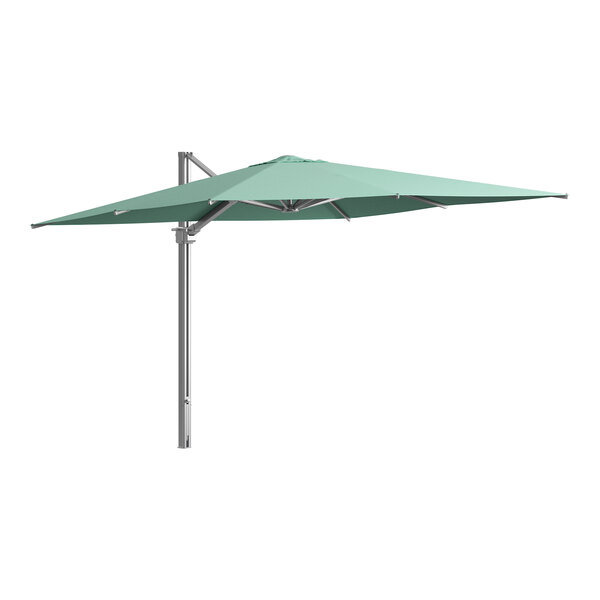 A green Lancaster Table & Seating cantilever umbrella on a metal pole.
