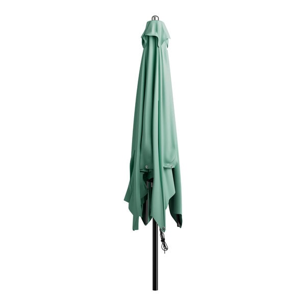 A green umbrella on a black pole.