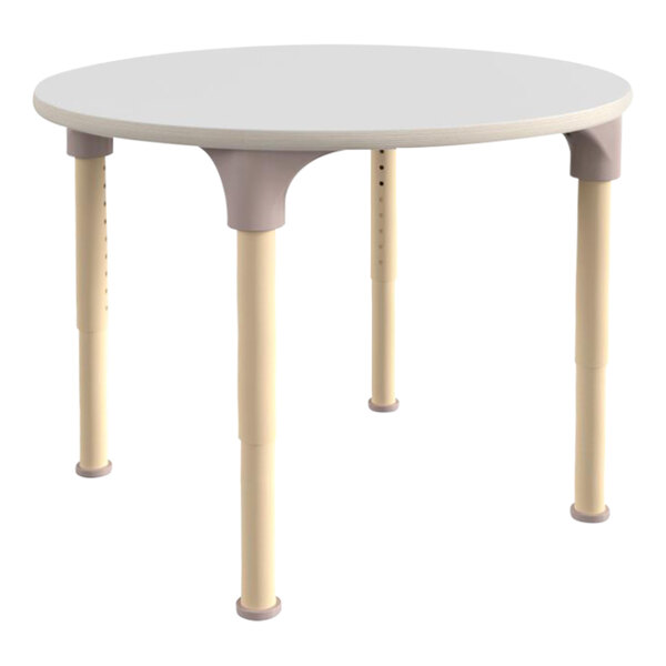 A white round table with beige legs.