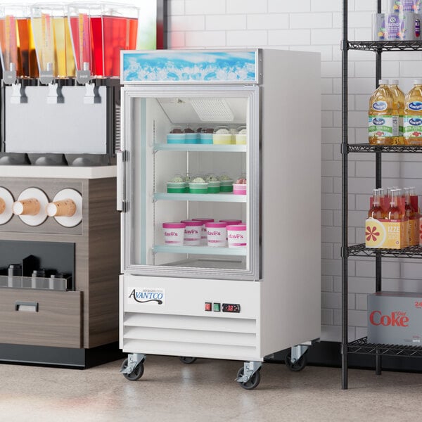 An Avantco swing glass door freezer with shelves holding ice cream containers.