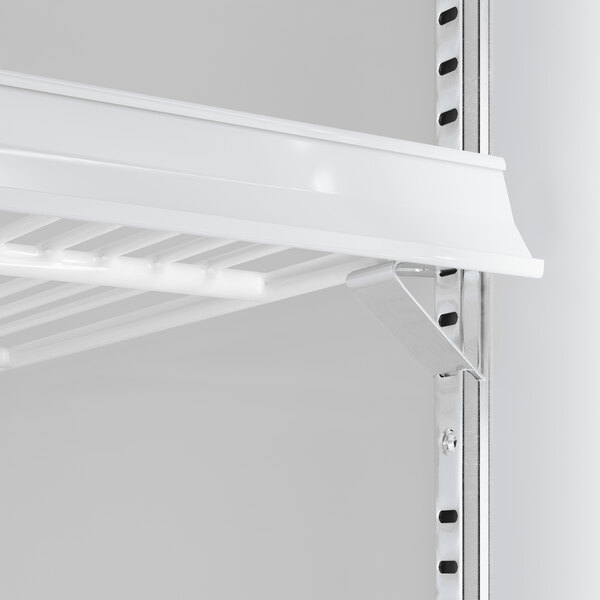 A close-up view of a white wire shelf and metal support bracket inside a commercial glass door refrigerator.