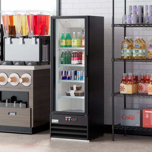 A black glass door merchandiser refrigerator with LED lighting, featuring a left-hinged swing door and stocked with beverages.