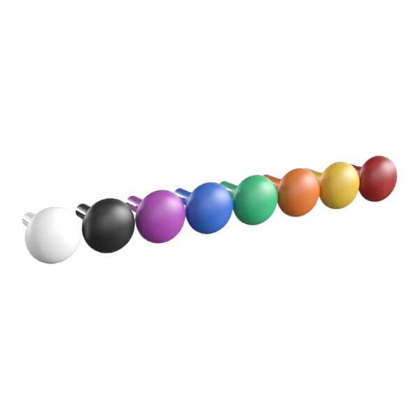 A row of colorful round objects including yellow, blue, green, red, and black balls.