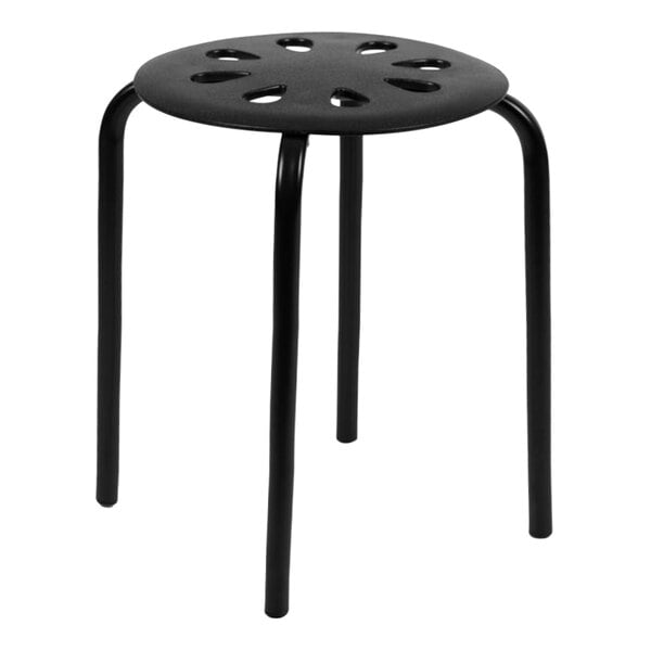 A set of 5 black plastic stackable stools with holes in the seats