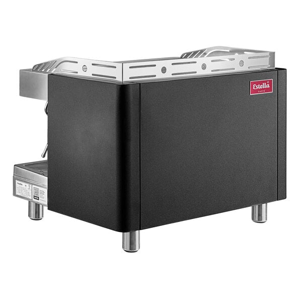A black and silver Estella Caffe Two Group Teapresso Machine on a counter in a professional kitchen.