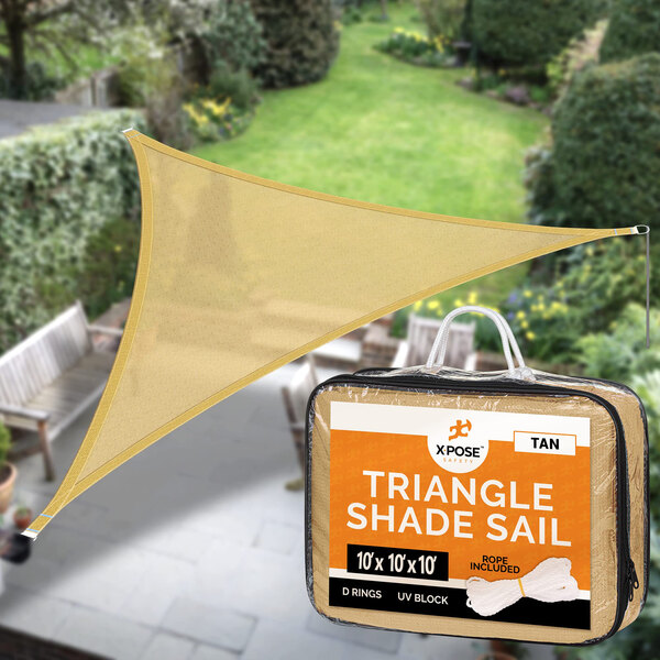 A tan triangular shade sail hanging outdoors.