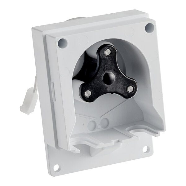 A white plastic object with a black and white motor and roller assembly.