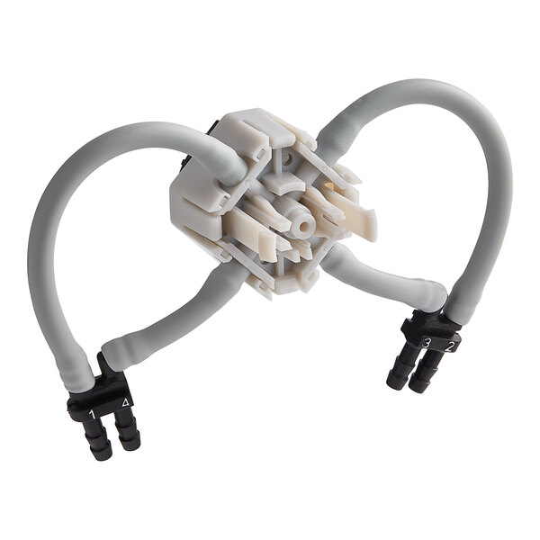 A white and black plastic Seko Selector Kit connector.