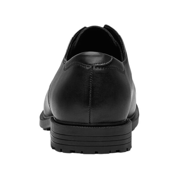 A black leather Shoes For Crews Senator dress shoe with a rubber sole.