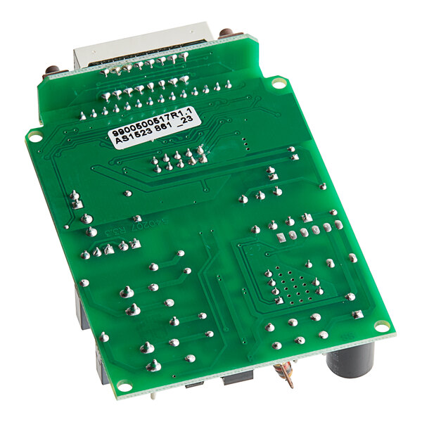 A green Seko circuit board with multiple components and many small holes.