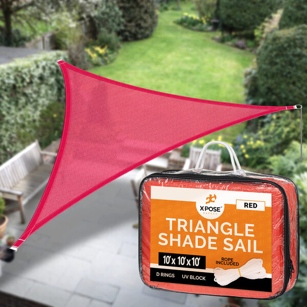 A red triangular shade sail over a patio.