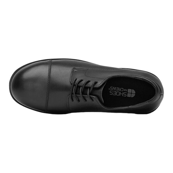 A black Shoes For Crews Senator dress shoe for men with laces.