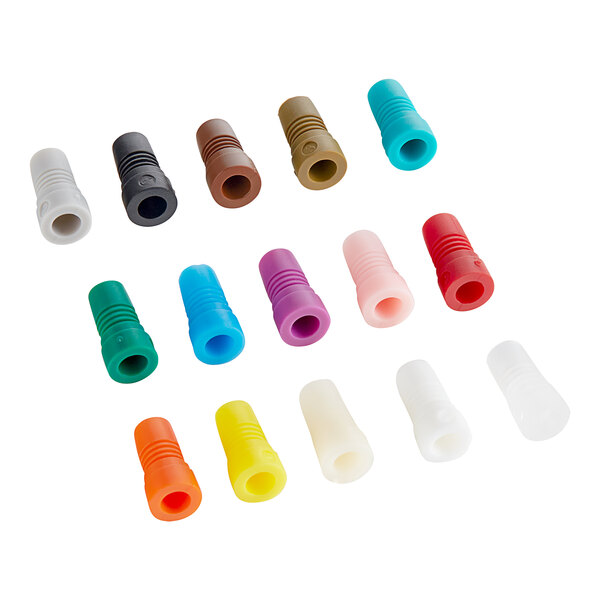 A variety of colorful plastic plugs with holes on a white background.