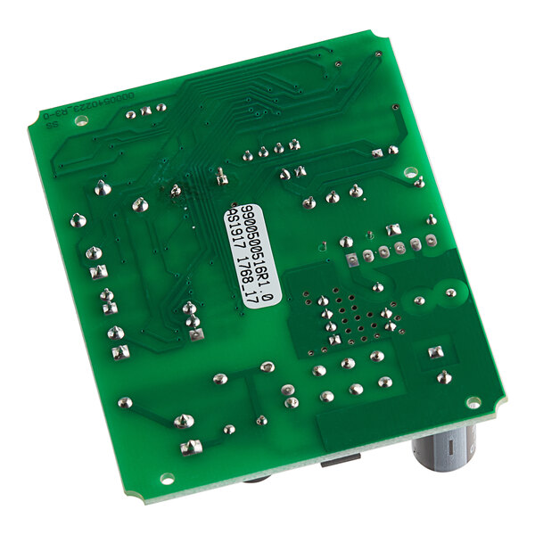 A green Seko circuit board with several components, silver and black numbers, and many small holes.