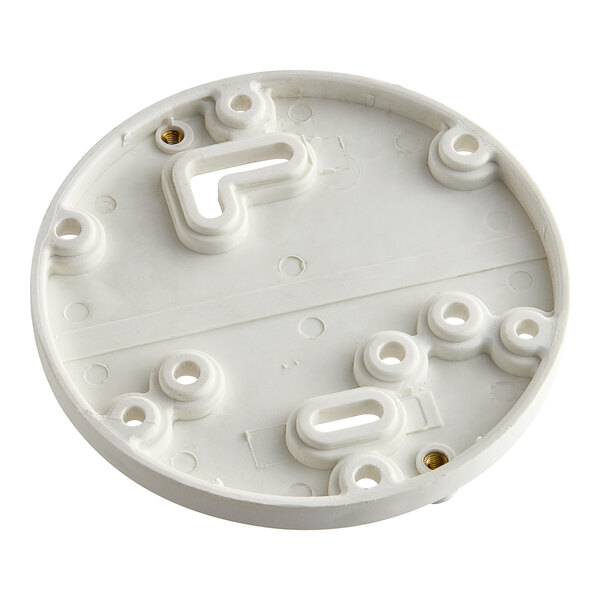 A white circular object with holes.