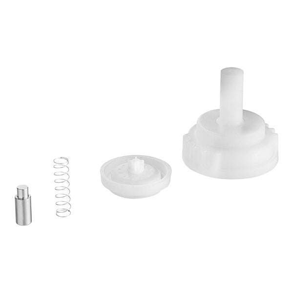 A white plastic valve with a spring and a metal cylinder.