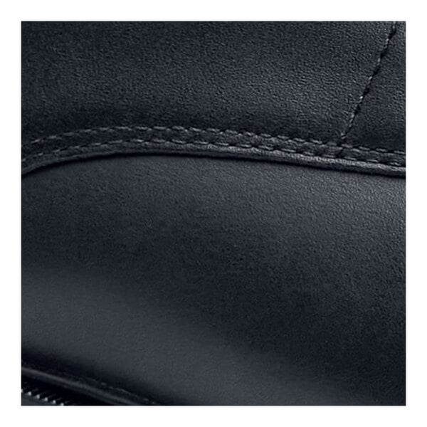 The side of a black leather Shoes For Crews Senator dress shoe with stitching.