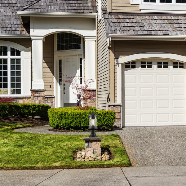 A matte black post mount light with a seeded glass shade on a white background.