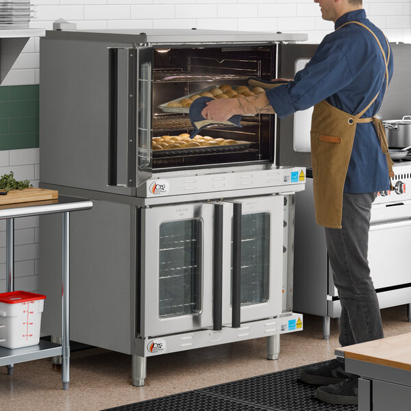 A double deck standard depth full size electric convection oven with glass doors, shown in a commercial kitchen setting.